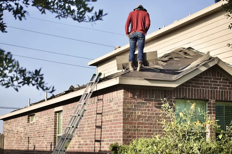 Professional roofer working on a residential roof in Lakecrest